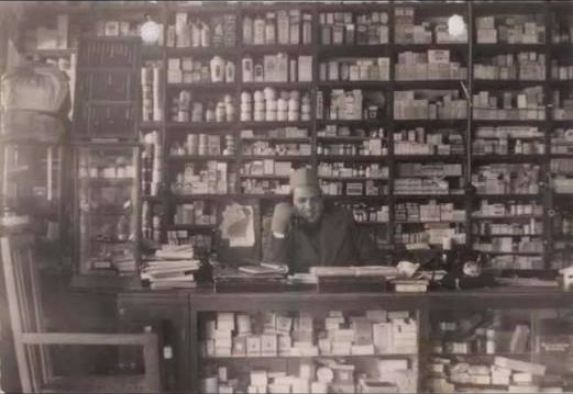 Behind the counter at the Gainda Mull Hem Raj shop in the early 1900s
